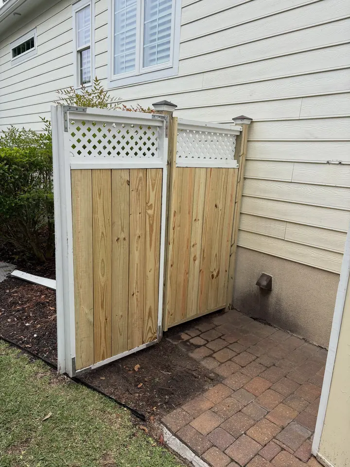 Trash can enclosure with new wood boards