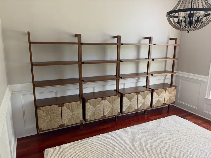 Wall of wooden shelving units installed in a homeschool room